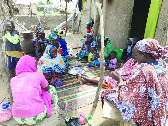 Women mourning with a bereaved Christian family after a murderous attack by Boko Haram on a camp for IDPs in Nguetchewe village