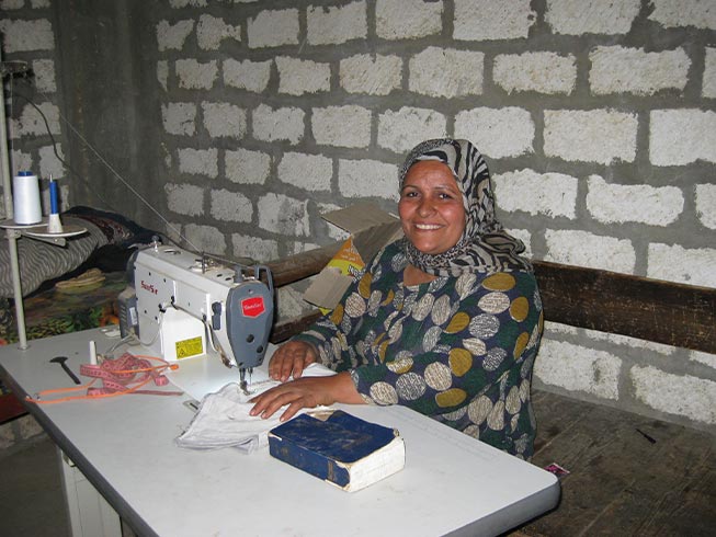 A Christian woman receives sewing training from the Barnabas supported project