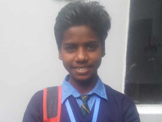 Akash's beaming smile shows how happy he is at his new Christian-run school, where he is free from harassment and bullying