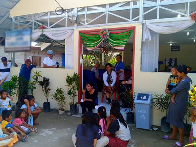 Christian families gather at the entrance to their new church building in Palu that was provided by Barnabas Fund