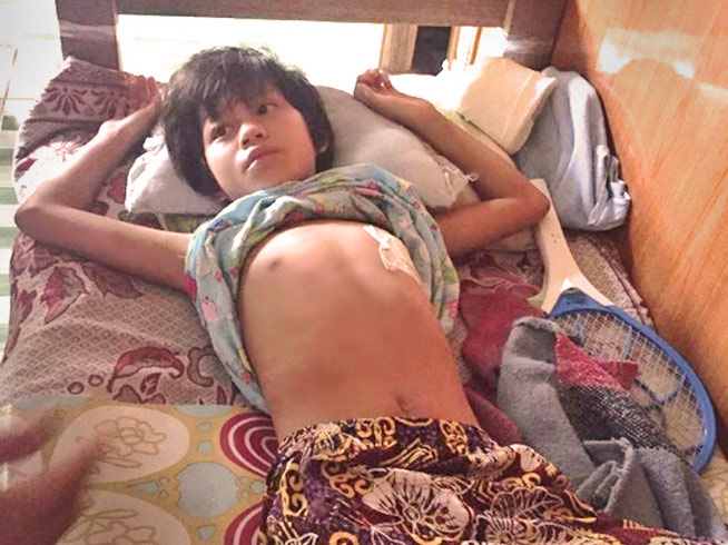 A Christian Kachin child being treated for shrapnel injury