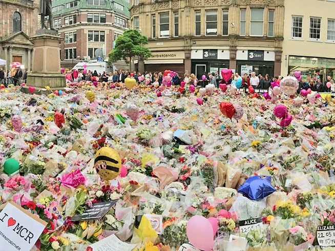 Floral tributes to the victims of the 2017 Manchester Arena bombing. Ur Rehman spoke alongside police chiefs and a family member of a victim of the IS-claimed terror attack